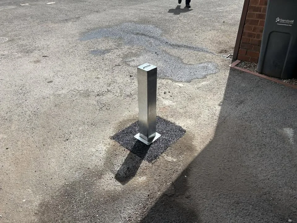 A real galvanised POSTSECURE telescopic security post installed at a driveway entrance