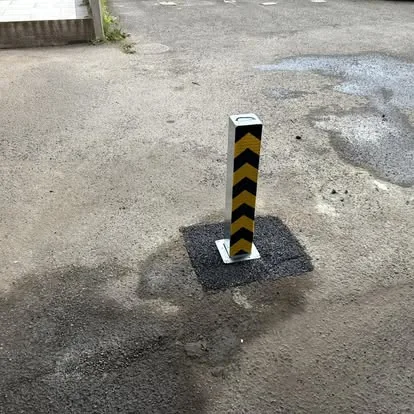 Raised Manual 100 post with a locally reinstated tarmac surround
