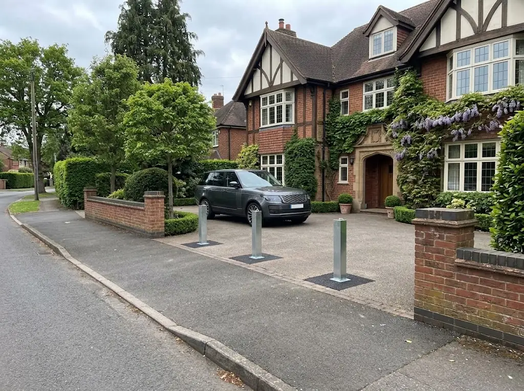 Three galvanised PostSecure telescopic security posts fitted across a residential driveway with a parked vehicle
