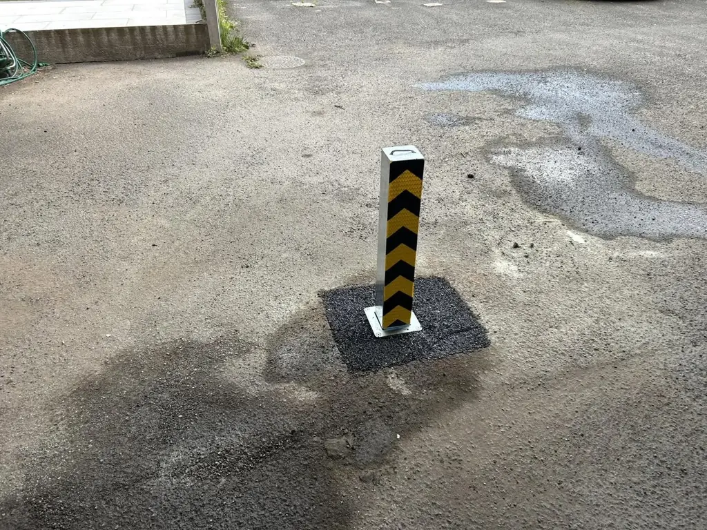 PostSecure Manual 100 with black and yellow chevron markings, installed